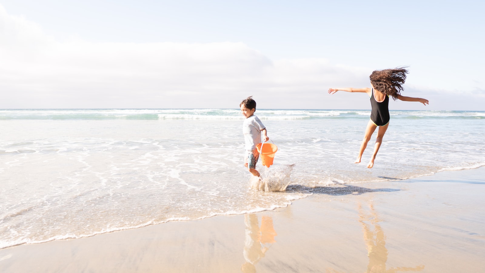 Children playing in the shallow water at the beach